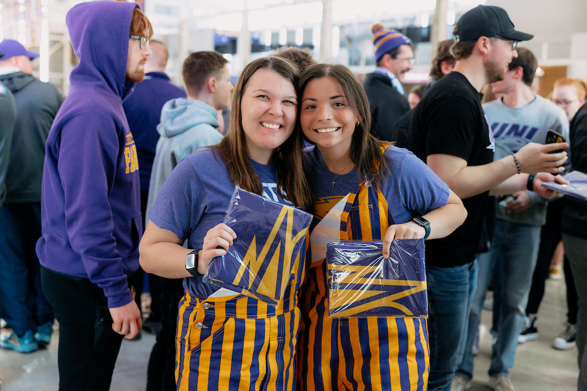 Students in purple and gold overalls
