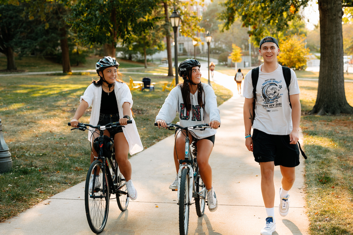Students writing bikes on UNI campus