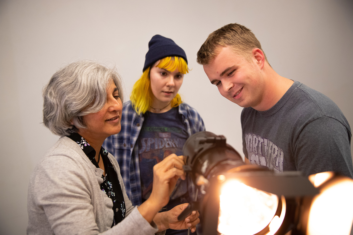 Ethan Ahrens looking at professional camera